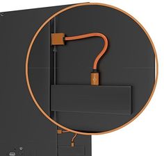 an orange cord is connected to the side of a black wall mounted speaker enclosure with a white background