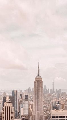 an aerial view of the empire building in new york city, with other tall buildings