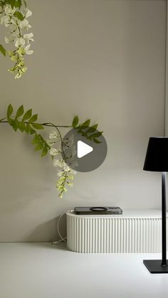 a white radiator sitting on top of a table next to a black lamp