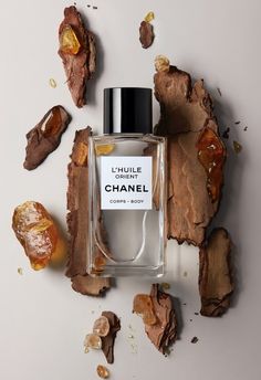 a bottle of chanel perfume surrounded by pieces of wood