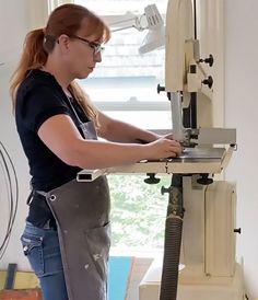 a woman working on a machine in a room