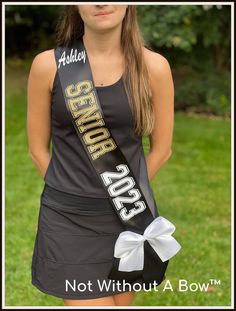 a young woman wearing a black and gold sash with the words, miss jones on it