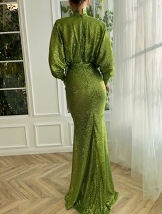 Let yourself be carried away by the breathtaking vivid green dress. Its sparkling lace fabric gives an unparalleled charm to your appearance. Carefully crafted, the loose turtleneck and mermaid silhouette complement each other beautifully. Dark Green Sequin Party Dress, Glamorous Green Mermaid Hem Gown, Dark Green Evening Dress For Gala, Dark Green Gala Evening Dress, Green Fishtail Gown For Wedding, Green Mermaid Fishtail Dress For Wedding, Green Fishtail Mermaid Dress For Wedding, Long Sleeve Green Mermaid Dress For Prom, Green Floor-length Mermaid Dress For Gala