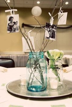 two vases filled with flowers sitting on top of a silver tray next to each other