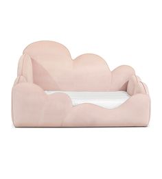 a pink cloud shaped bed sitting on top of a white floor