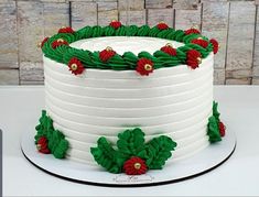 a white cake with green and red decorations