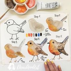 a person is painting birds with watercolors