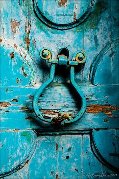 an old blue door with a metal handle