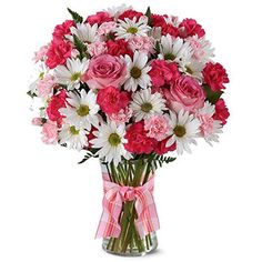 a vase filled with pink and white flowers