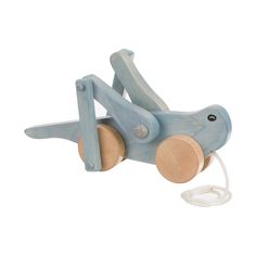 a wooden toy that is shaped like a dog with wheels on it's back