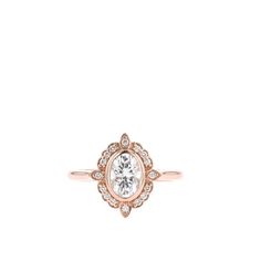 a gold ring with a white diamond in the center and two small diamonds around it