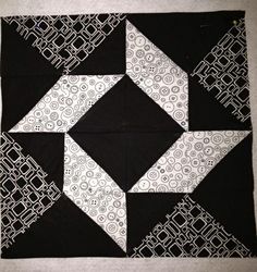 a black and white quilted square with an intricate design