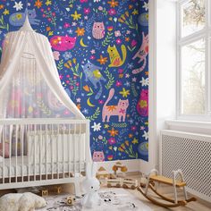 a baby's room with blue and pink wallpaper