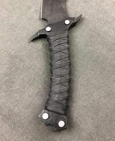 a knife with black leather wrapped around it