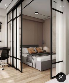 a bedroom with an open glass door leading to the bed and desk in front of it