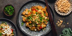 an overhead view of a plate of food with chopsticks next to it and two bowls of vegetables on the side