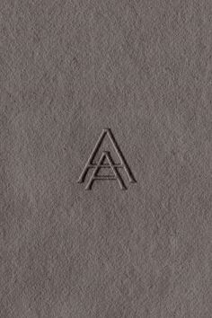 an image of a logo that is made out of concrete and has the letter a on it