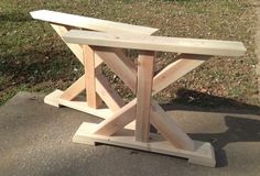 a wooden bench sitting on top of a sidewalk