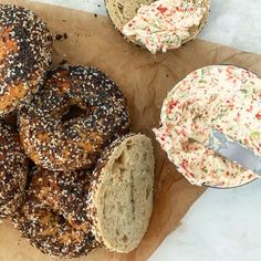 bagels with sprinkles and dip are on the table