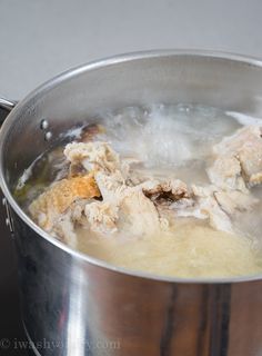 a silver pot filled with soup on top of a stove