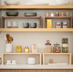 the shelves are filled with different types of food and kitchen utensils on them