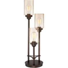 three light floor lamp with glass shades on the top and bottom, in an antique bronze finish