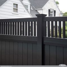 an image of a black fence in front of a house