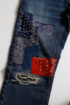 an old pair of jeans with patchwork on the back and red, white, and blue patches