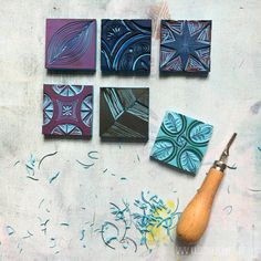 four different types of tile on a table with a wood carving tool and paintbrush