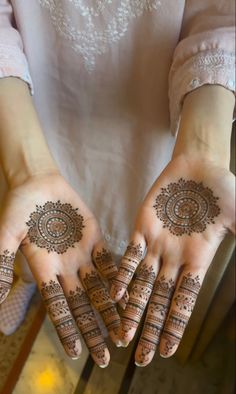 two hands with henna designs on them