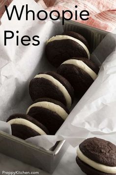 chocolate whoopie pies in a baking tin with white frosting on top