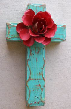 a cross with a red flower on it