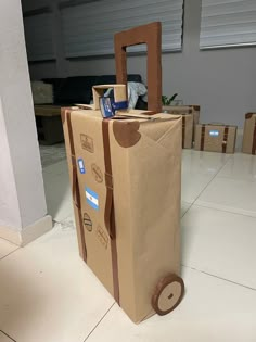 a cardboard bag sitting on top of a white floor next to boxes and a door