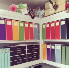 an organized office space with colorful file cabinets