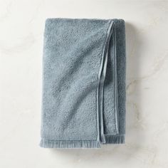 a blue towel folded on top of a white counter