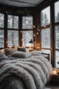 a large bed sitting next to a window covered in lights