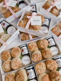 several boxes filled with different types of pastries on top of a white tablecloth