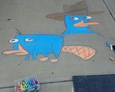 two blue birds painted on the sidewalk next to crayons