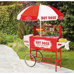 a hot dog cart with an umbrella on the top and two buns under it