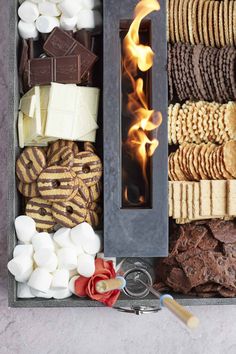 an assortment of cookies, marshmallows, and crackers in a box