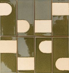 several square tiles with white and green designs on them