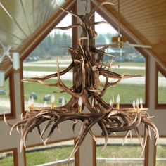 a chandelier made out of antlers hanging from a ceiling in a room