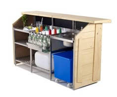 an open cabinet with bottles and containers on the bottom shelf, next to a blue trash can