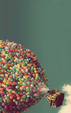 the balloon is floating in the sky with its parachutes full of colorful balls and streamers