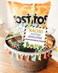 a bucket filled with lots of goodies on top of a wooden table