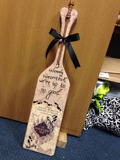 a wooden spoon with a quote on it