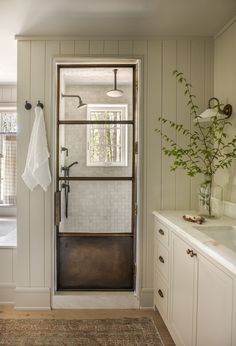 a bathroom with white walls and wooden floors