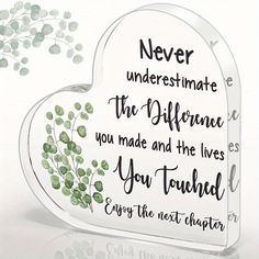 a heart shaped plaque with the words never underestimate