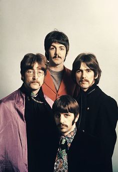 the beatles posing for a black and white photo