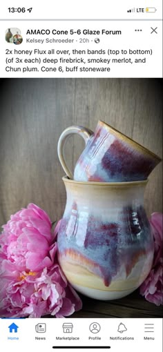 two vases sitting on top of a wooden table next to pink peonies